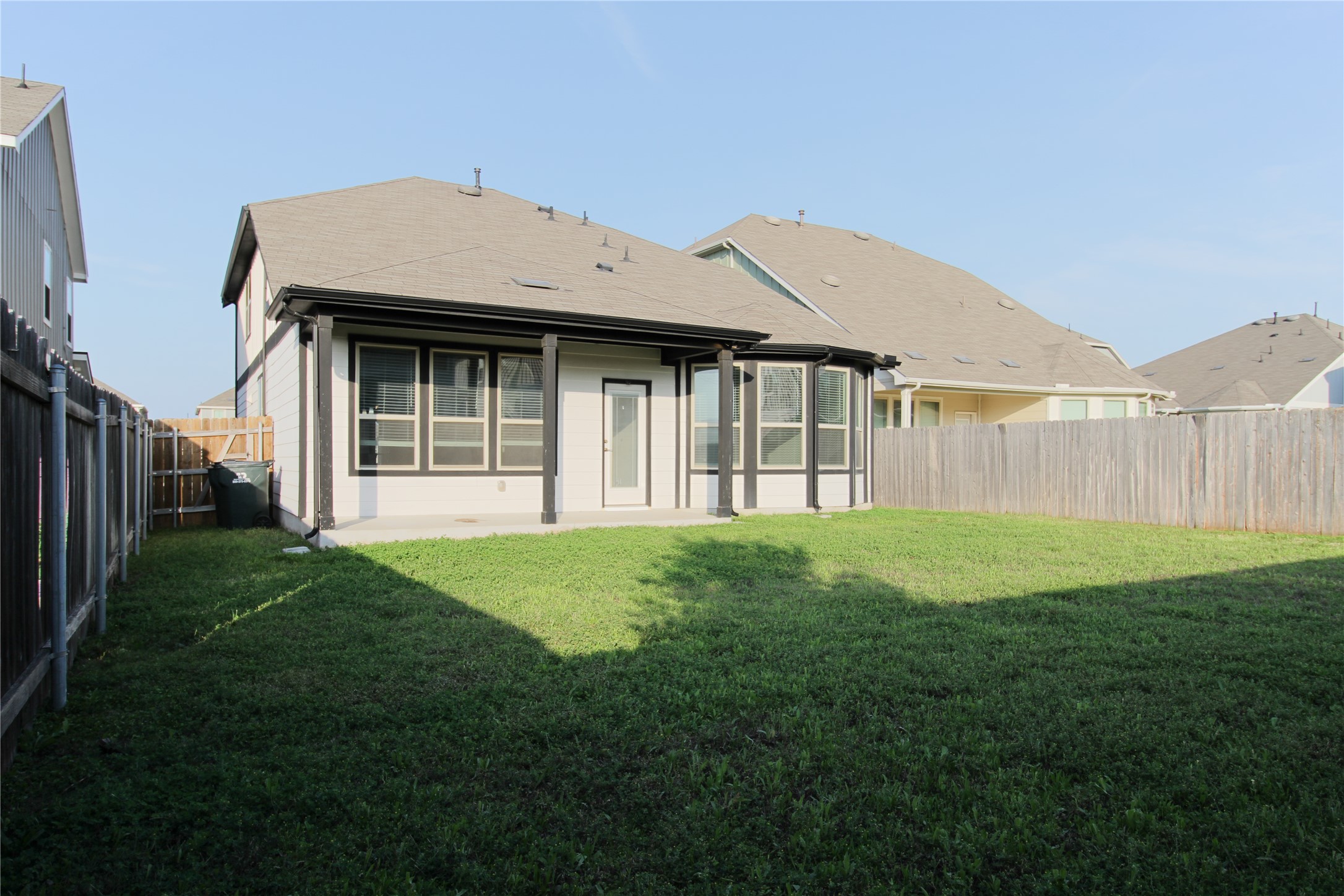109 Yellow Thistle Cove Georgetown, TX 78626 - Photo 33 of 36 Expansive backyard featuring a covered patio, privacy fencing, and a manicured lawn