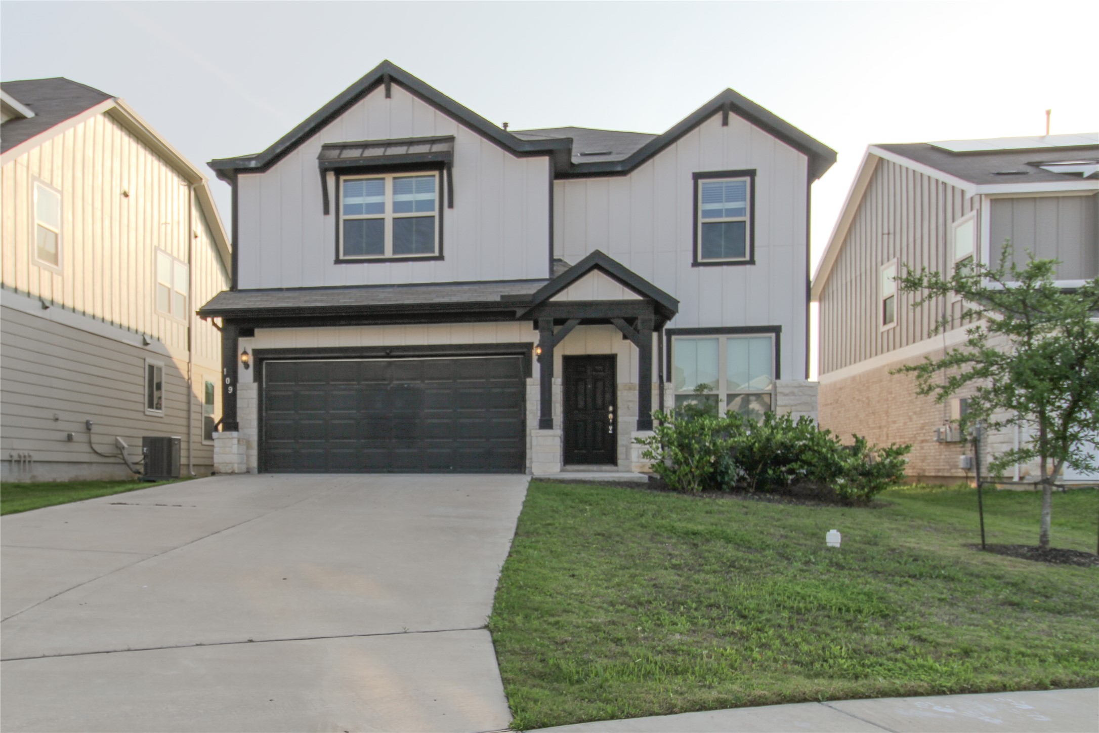 109 Yellow Thistle Cove Georgetown, TX 78626 - Photo 34 of 36 Modern farmhouse-style exterior featuring vertical white siding with dark trim accents