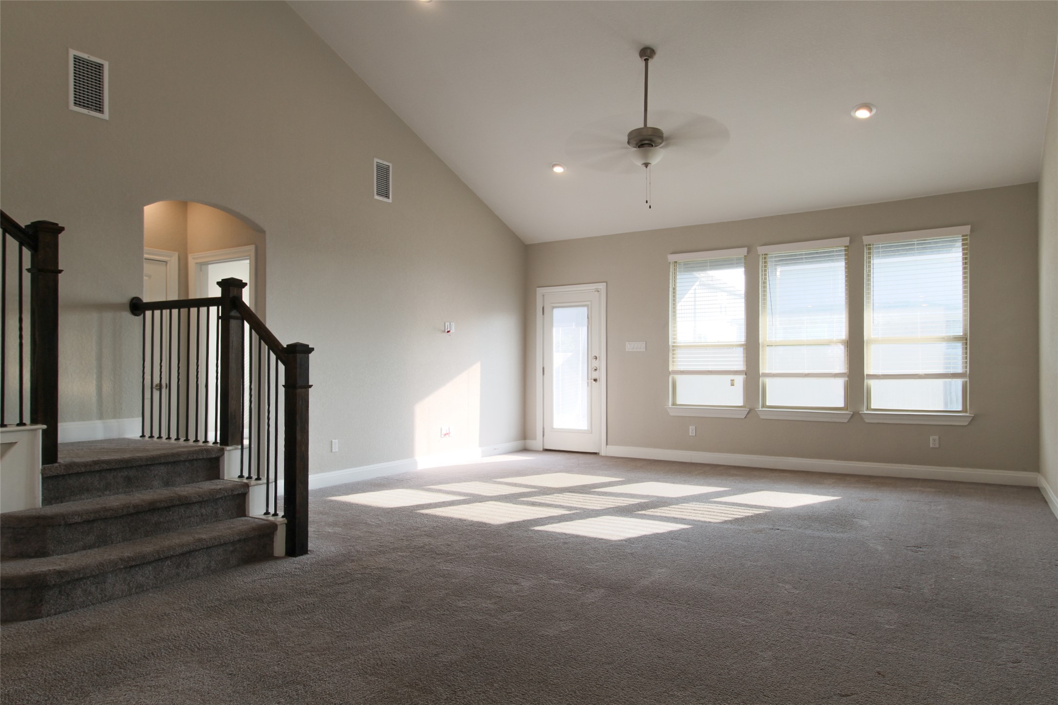 109 Yellow Thistle Cove Georgetown, TX 78626 - Photo 9 of 36 Spacious living area featuring a vaulted ceiling and neutral-toned carpeting