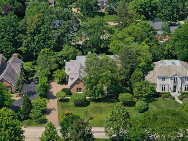 an aerial view of a house with yard and outdoor seating
