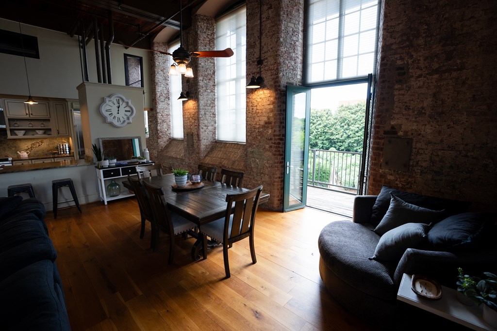 1201 Front Avenue, Unit 203 Columbus, GA 31901 - Photo 12 of 54 a living room with furniture a large window and wooden floor