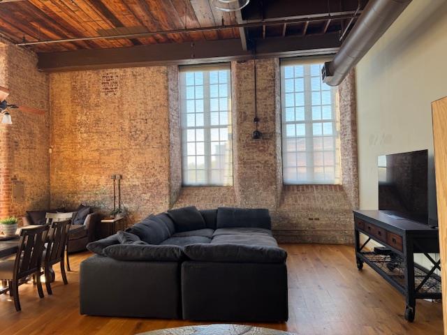 1201 Front Avenue, Unit 203 Columbus, GA 31901 - Photo 17 of 54 a living room with furniture and a flat screen tv