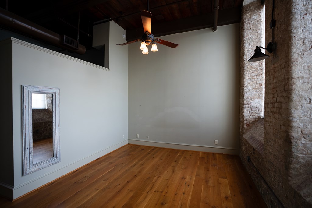 1201 Front Avenue, Unit 203 Columbus, GA 31901 - Photo 31 of 54 wooden floor in an empty room with a window