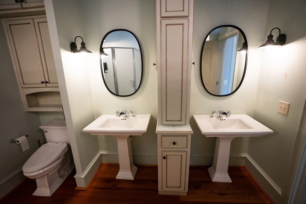 1201 Front Avenue, Unit 203 Columbus, GA 31901 - Photo 33 of 54 a bathroom with a toilet a sink and a mirror