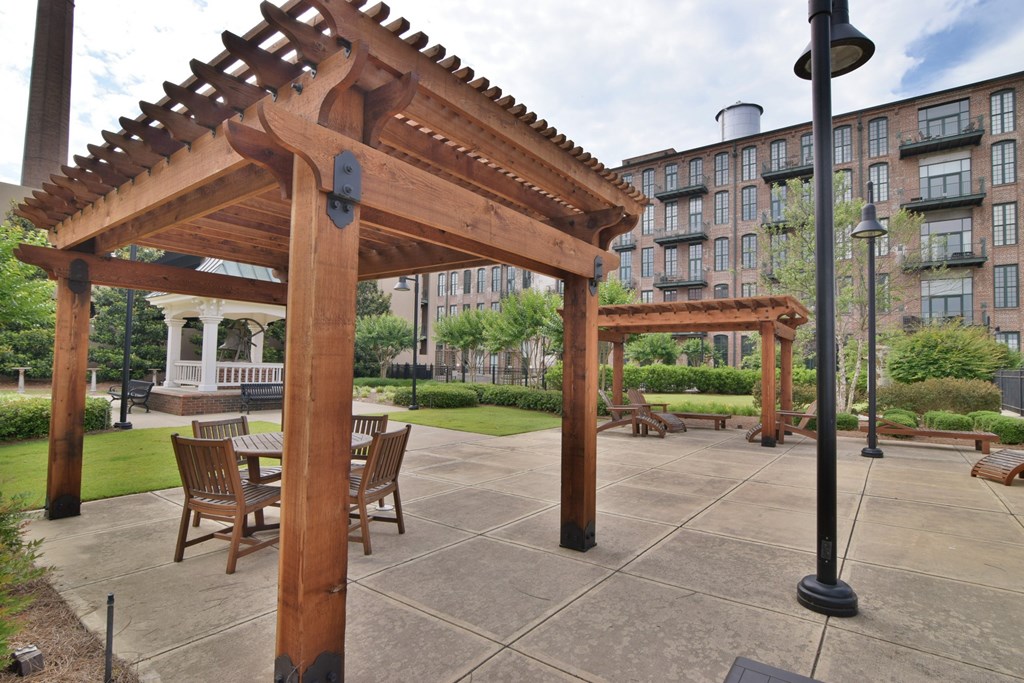 1201 Front Avenue, Unit 203 Columbus, GA 31901 - Photo 48 of 54 a view of a patio with a table chairs and a slide