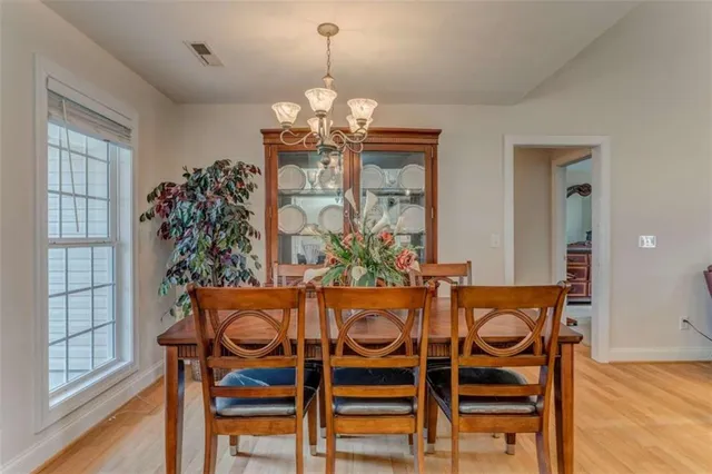 a view of a dining room with furniture window and wooden floor