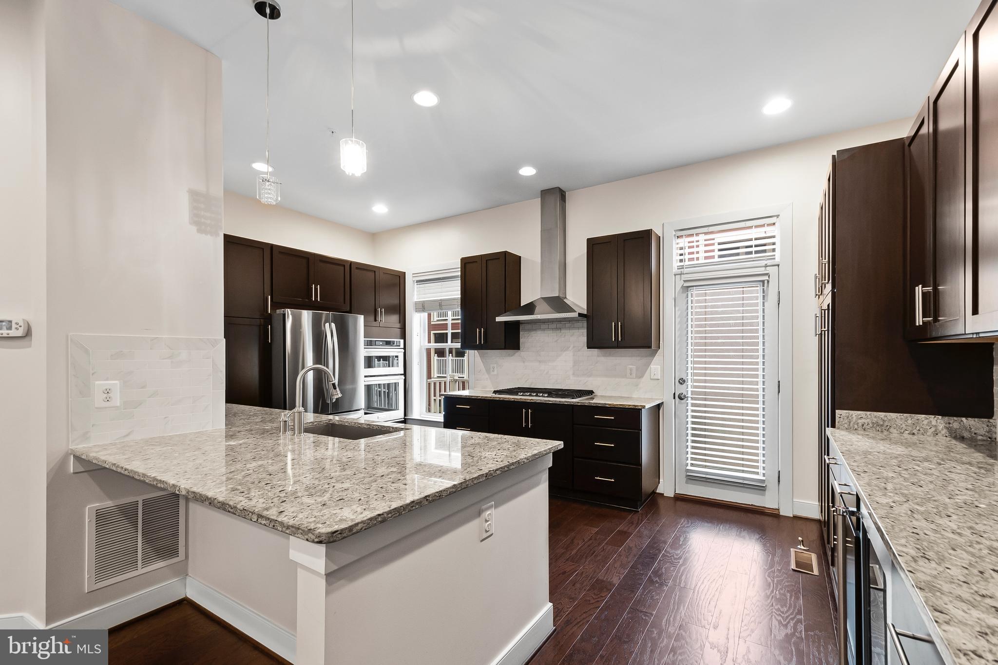 1417 Van Valkenburgh Lane Alexandria, VA 22301 - Photo 15 of 45 a kitchen with stainless steel appliances granite countertop a refrigerator a stove top oven a sink dishwasher and wooden cabinets with wooden floor