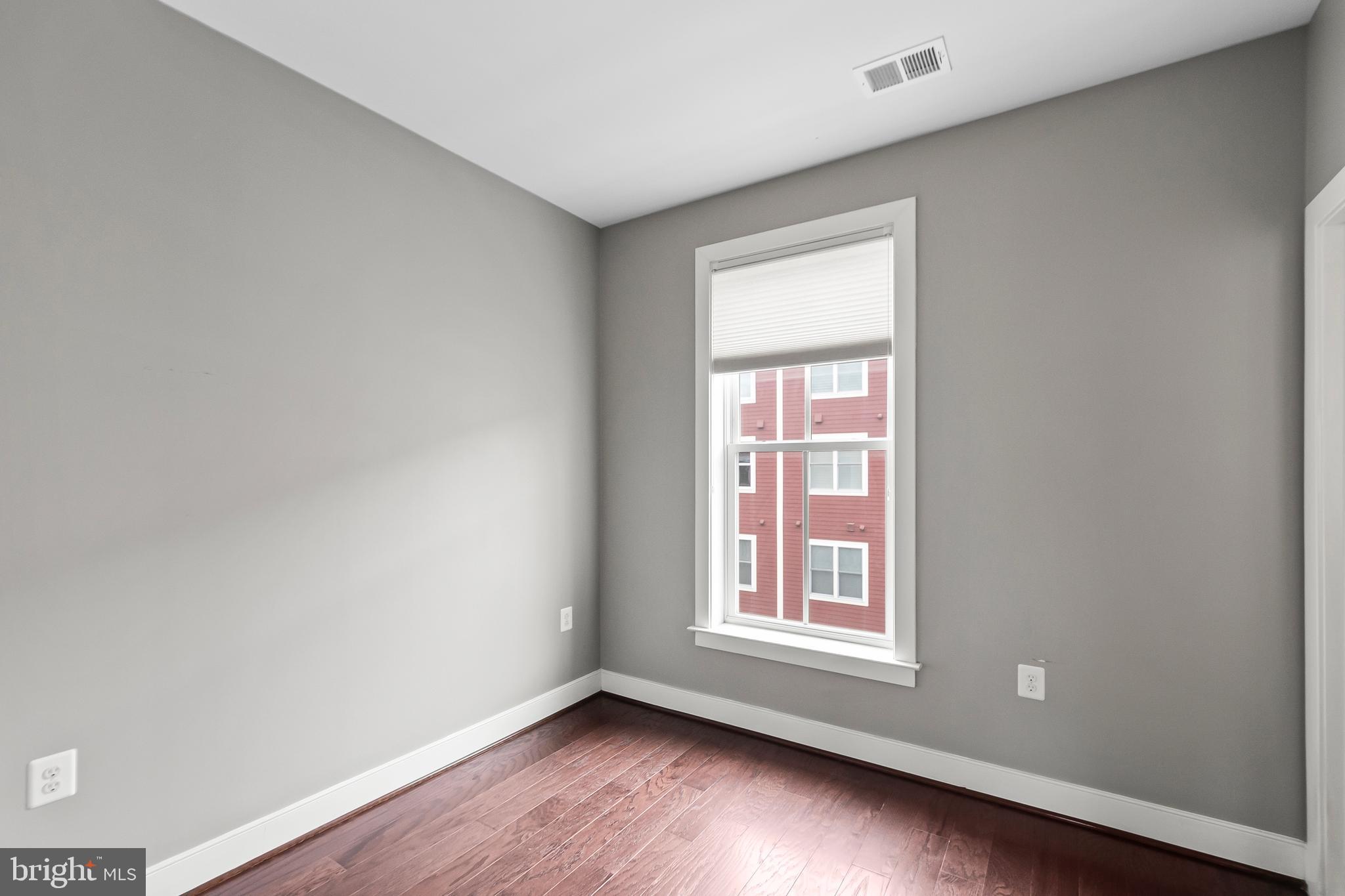 1417 Van Valkenburgh Lane Alexandria, VA 22301 - Photo 22 of 45 a view of an empty room with wooden floor and a window
