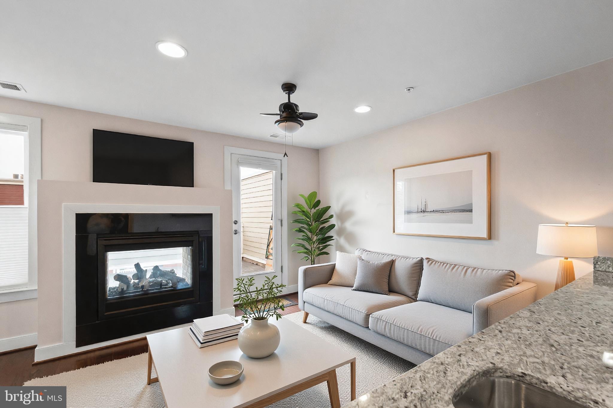 1417 Van Valkenburgh Lane Alexandria, VA 22301 - Photo 34 of 45 a living room with furniture a fireplace and a flat screen tv