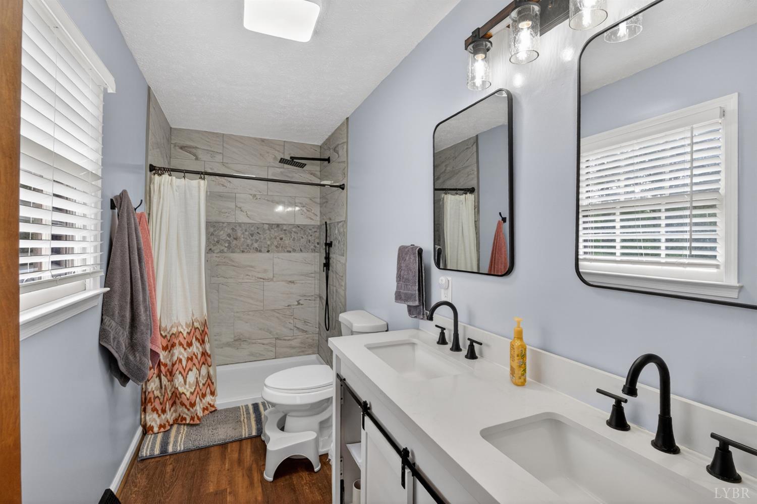 1002 Homeplace Road Rustburg, VA 24588 - Photo 27 of 48 a bathroom with a sink a toilet and shower