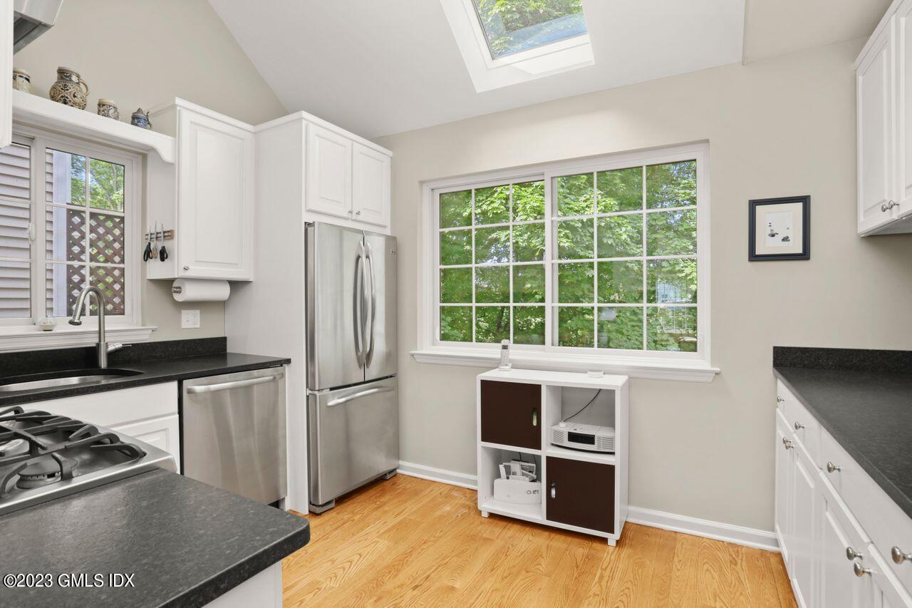 1 Shore Road, Unit 3 Stamford, CT 06902 - Photo 14 of 37 a kitchen with wooden cabinets and a stove top oven