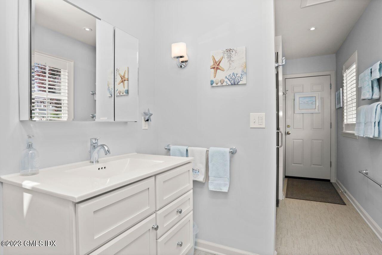 1 Shore Road, Unit 3 Stamford, CT 06902 - Photo 20 of 37 a bathroom with a sink and a mirror