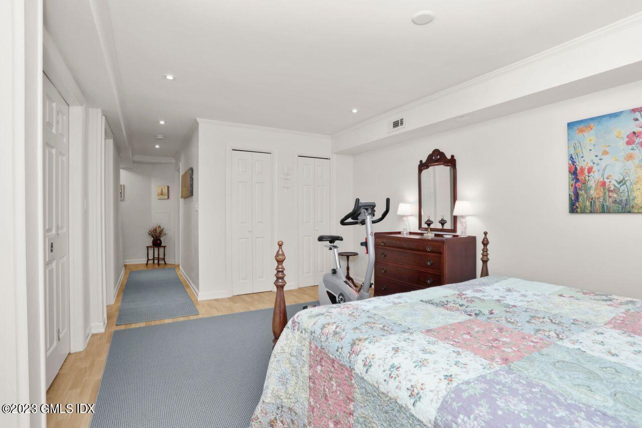 1 Shore Road, Unit 3 Stamford, CT 06902 - Photo 30 of 37 a bedroom with a bed and a chandelier