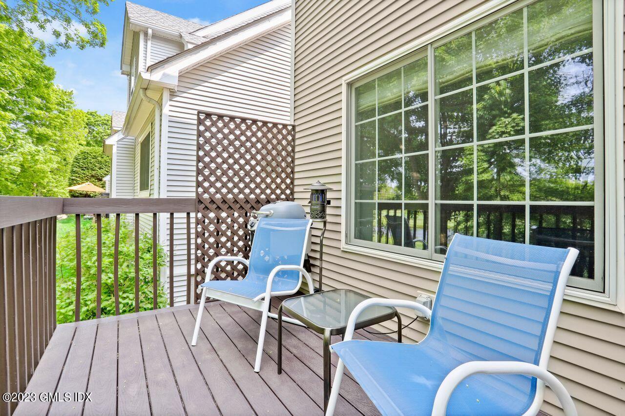 1 Shore Road, Unit 3 Stamford, CT 06902 - Photo 31 of 37 a view of a deck with a table and chairs
