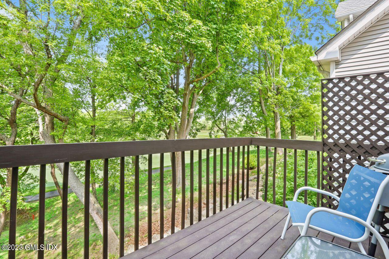1 Shore Road, Unit 3 Stamford, CT 06902 - Photo 32 of 37 a view of a chair in wooden deck