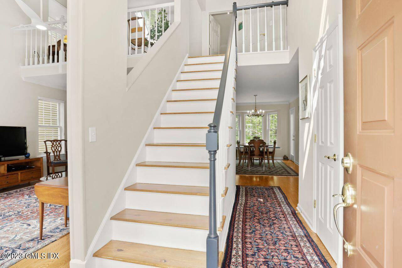 1 Shore Road, Unit 3 Stamford, CT 06902 - Photo 4 of 37 a view of a hallway with wooden floor and staircase