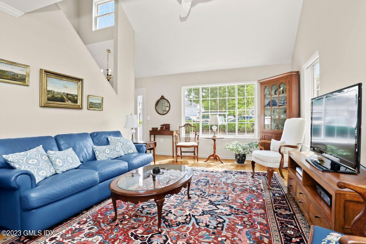 1 Shore Road, Unit 3 Stamford, CT 06902 - Photo 8 of 37 a living room with furniture a large window and a flat screen tv