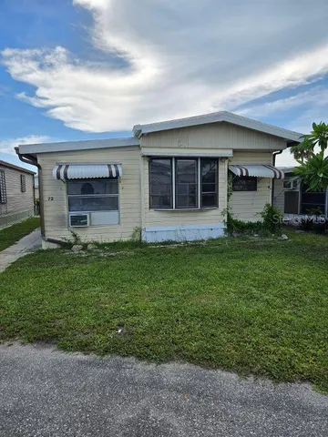 a large tree in front of a house