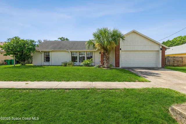 a front view of house with yard and green space