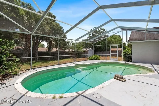a view of a backyard with a tub and wooden fence