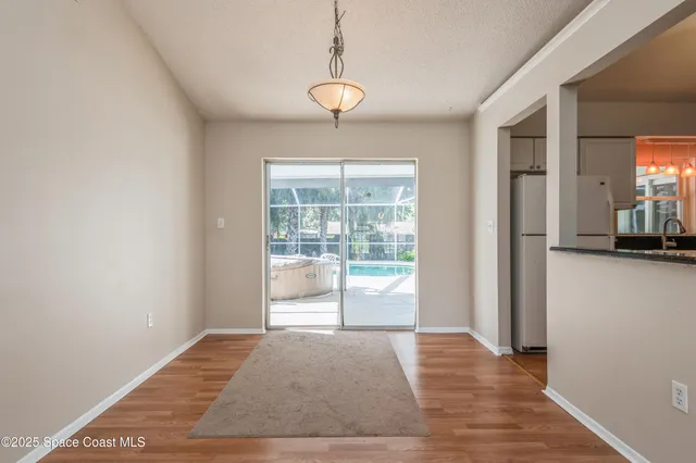 a view of a room with wooden floor and a window