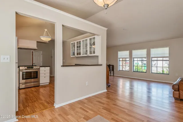 a view of a kitchen cabinets and wooden floor