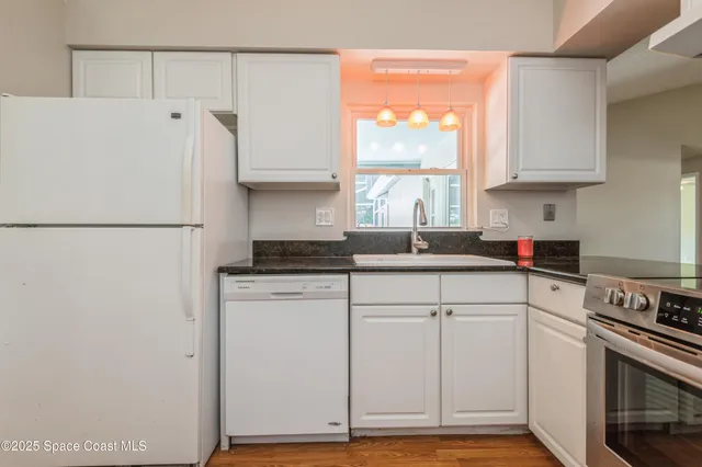 a white refrigerator freezer sitting inside of a kitchen