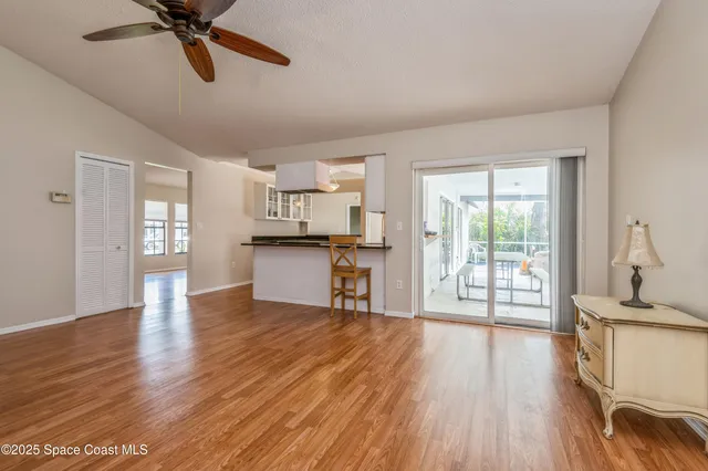 a view of open kitchen with wooden floor and outdoor space