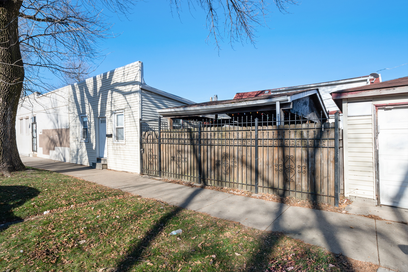 2857 South Kostner Avenue Chicago, IL 60623 - Photo 4 of 21 a view of backyard with large trees and wooden fence