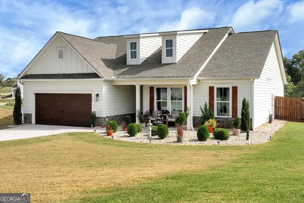 a front view of house with outdoor seating and yard