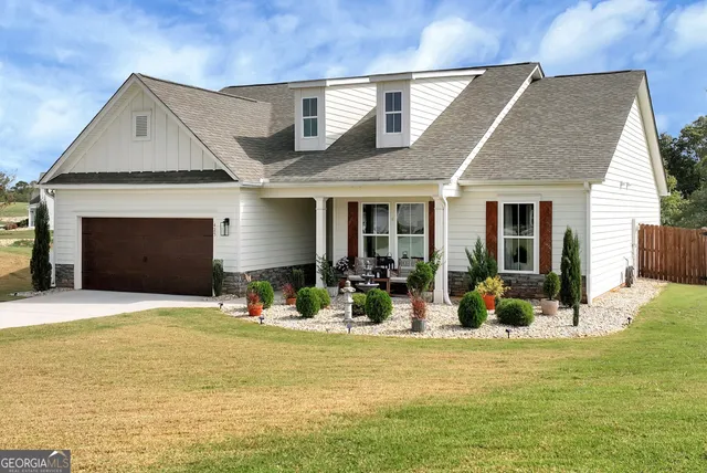 a front view of house with outdoor seating and yard