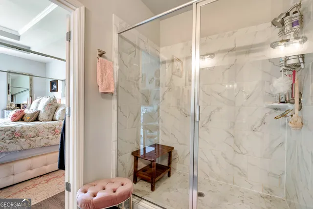 a en suite bathroom with a granite countertop shower