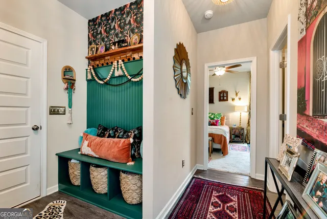 an entryway with wooden floor and a rug