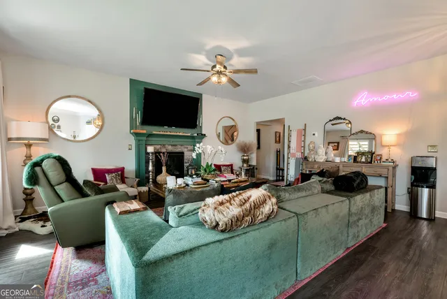 a living room with fireplace furniture and a flat screen tv