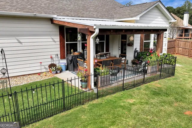 a view of a house with wooden deck and furniture