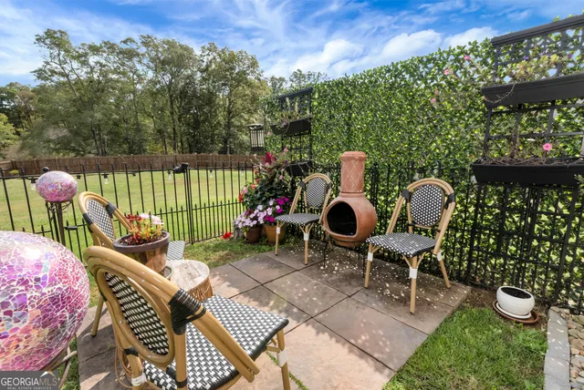 a view of a chairs and table in backyard