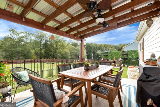 a view of an outdoor dining space with furniture and wooden floor