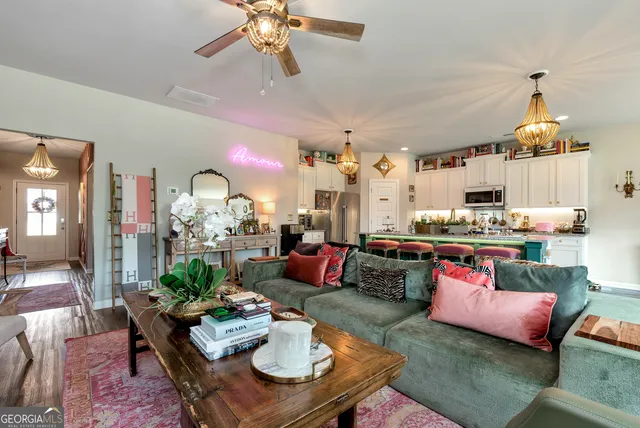 a living room with furniture kitchen view and a table