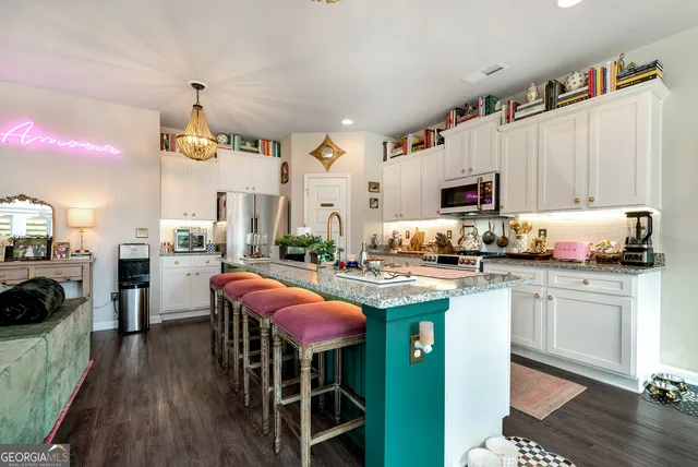 a kitchen with granite countertop a sink cabinets and window