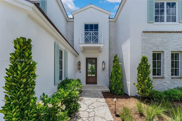 a front view of a house with garden