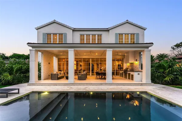 a kitchen with stainless steel appliances granite countertop a sink a stove and a granite counter tops with white cabinets next to a window