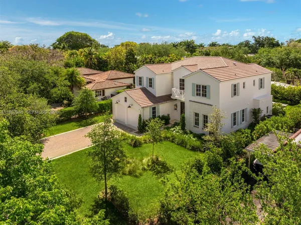 a view of a hallway with wooden floor and stairs