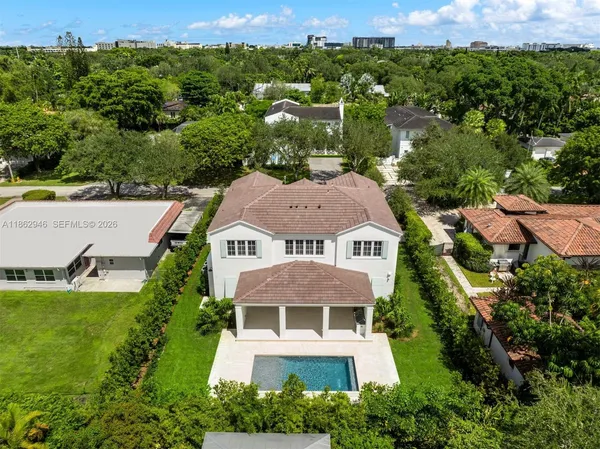 an aerial view of multiple houses with yard