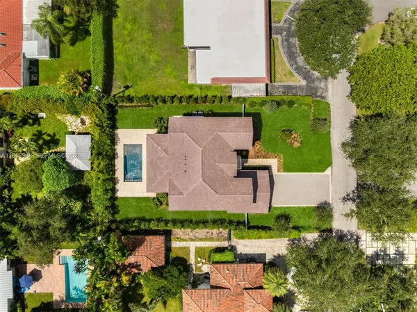 an aerial view of a house with outdoor space pool seating area and yard