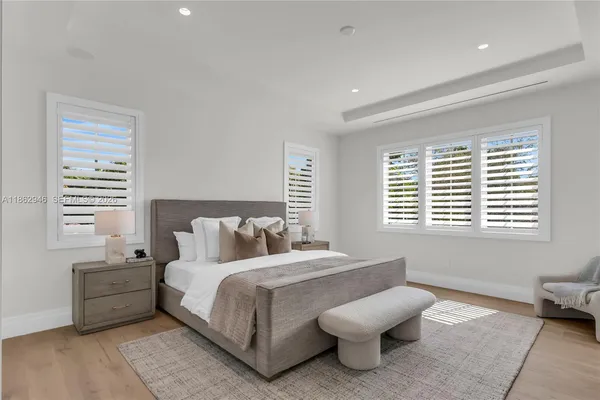 a spacious bedroom with a bed and a window