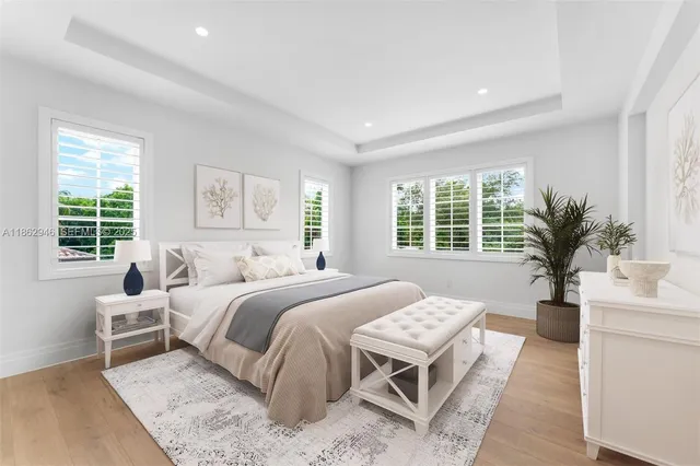 a bedroom with a large bed and a large window