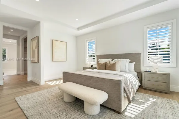 a living room with furniture a rug and white walls