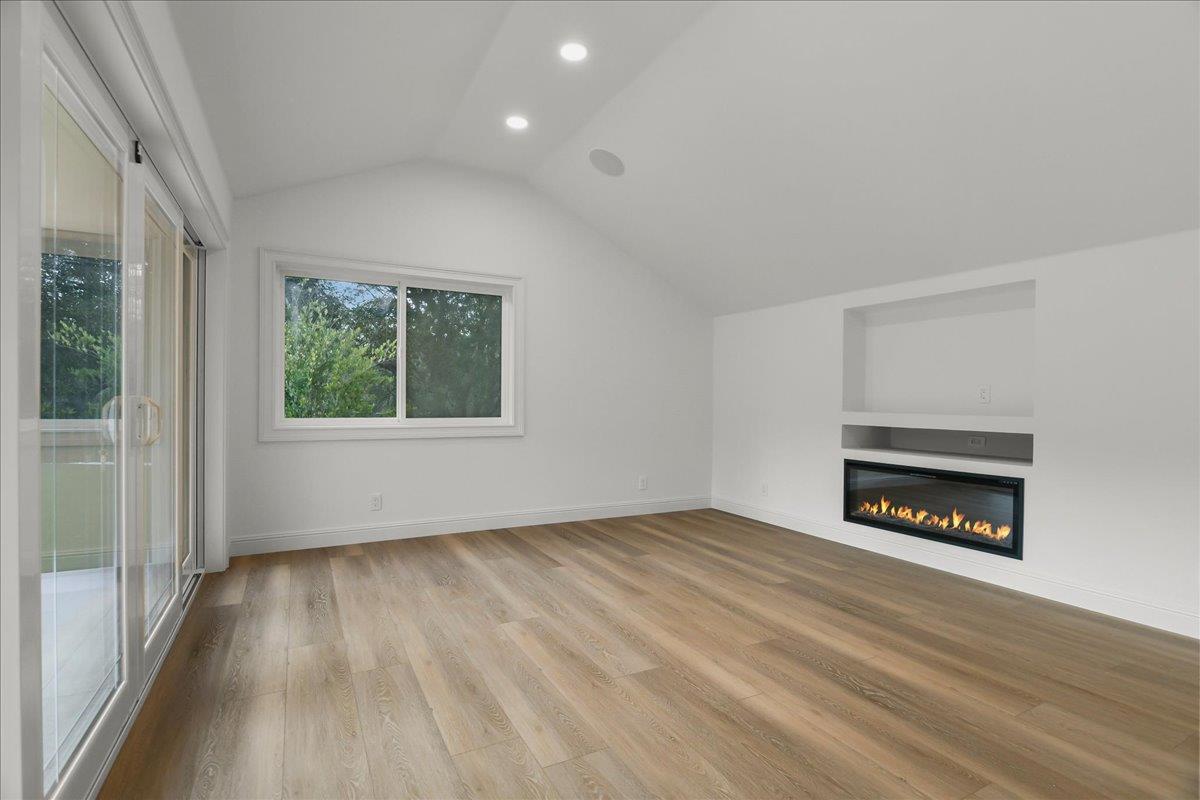 18911 Decatur Road Los Gatos, CA 95030 - Photo 91 of 143 an empty room with wooden floor fire place and windows