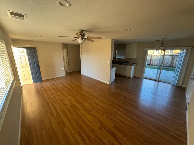 wooden floor in an empty room with a window