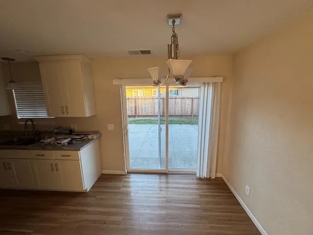 a kitchen with a stove and a wooden floor